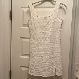 Never worn, stretches, side zipper.